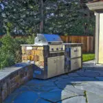 Outdoor BBQ grill and kitchen area with matching pavers in Atherton landscape design