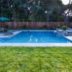 Modern backyard pool surrounded by paver stone deck in Atherton landscape project