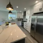 Gray-veined granite countertops & pendant lighting