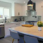 Contemporary Sunnyvale kitchen with oak wood floors, marble-look backsplash, and black fixtures
