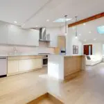 Open-concept West San Jose kitchen remodel with wood lower cabinets and central island