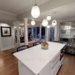 Modern Palo Alto kitchen with large white marble island, pendant lighting, and custom cabinetry