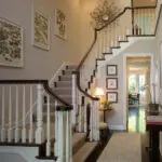 Foyer staircase with mocha wood accents and white framing in Menlo Park home remodel