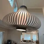 luxurious pendant lighting over dining room table.
