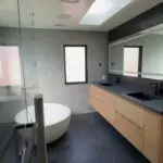 Modern bowl tub with floating dual sinks.