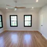 Master bedroom with striking black windows.