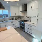 Gray-veined granite countertops & pendant lighting