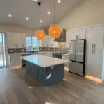 San Jose home remodel showcasing mosaic tile backsplash, stone-style countertops, and luxury kitchen upgrades after fire restoration.