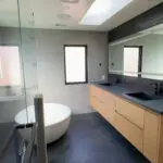 Modern bowl tub with floating dual sinks.